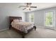 Cozy bedroom with a large bed, ceiling fan, and access to the outside at 3191 Moonlight Dr, Charleston, SC 29414