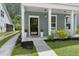 Cozy front porch features rocking chairs and beautiful landscaping at 3191 Moonlight Dr, Charleston, SC 29414