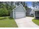 Detached garage with a wide driveway and attractive landscaping at 3191 Moonlight Dr, Charleston, SC 29414