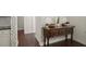Stylish hallway featuring hardwood floors, decorative wallpaper, and a classic wooden console table at 3191 Moonlight Dr, Charleston, SC 29414