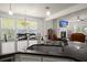 Kitchen with bar top seating, connecting to a dining room and cozy fireplace area at 3191 Moonlight Dr, Charleston, SC 29414