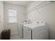Convenient laundry room with modern washer and dryer units and overhead shelving at 3191 Moonlight Dr, Charleston, SC 29414