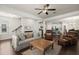 Open-concept living room with hardwood floors connecting to the kitchen and dining area at 3191 Moonlight Dr, Charleston, SC 29414
