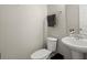 Cozy powder room with a pedestal sink, toilet, and decorative hand towel rack at 3191 Moonlight Dr, Charleston, SC 29414