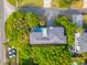 Aerial view of a beautiful home with a pool, lush landscaping, and a spacious rooftop deck near the beach at 3301 Palm Blvd, Isle of Palms, SC 29451