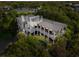 Stunning aerial view of a luxurious two-story home featuring a private pool, lush landscaping, and spacious balconies at 3301 Palm Blvd, Isle of Palms, SC 29451