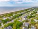 Aerial view of the beachfront neighborhood with a beach in the distance at 3301 Palm Blvd, Isle of Palms, SC 29451