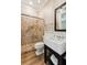 Bathroom featuring an updated shower with decorative tile and modern fixtures at 3301 Palm Blvd, Isle of Palms, SC 29451