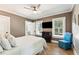 Bedroom featuring windows, television and blue chair at 3301 Palm Blvd, Isle of Palms, SC 29451
