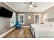 Bedroom featuring two windows, a ceiling fan, and hardwood floors at 3301 Palm Blvd, Isle of Palms, SC 29451