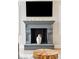 Close-up view of the fireplace, complete with a decorative mantle and ceramic vase at 3301 Palm Blvd, Isle of Palms, SC 29451