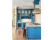 Blue kitchen with a central island, wine fridge, and custom cabinetry at 3301 Palm Blvd, Isle of Palms, SC 29451
