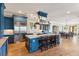 Spacious kitchen with a large central island, stainless steel appliances, and custom blue cabinetry at 3301 Palm Blvd, Isle of Palms, SC 29451