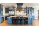Well-lit kitchen featuring a central island, stainless appliances, and blue cabinetry at 3301 Palm Blvd, Isle of Palms, SC 29451