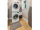 Convenient laundry room with stacked washer and dryer and a utility sink at 3301 Palm Blvd, Isle of Palms, SC 29451