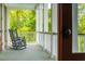 Relaxing covered porch with rocking chairs and scenic views at 3301 Palm Blvd, Isle of Palms, SC 29451
