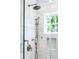 Close up of marble shower with dual shower heads and window at 3301 Palm Blvd, Isle of Palms, SC 29451