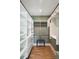 Spacious walk-in closet with custom shelving, drawers, and hardwood floors at 3301 Palm Blvd, Isle of Palms, SC 29451
