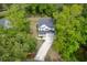 A stunning aerial view shows a two-story home with beautiful landscaping and a long driveway surrounded by lush trees at 3361 Olivia Marie Ln, Johns Island, SC 29455