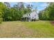 Large backyard with grass and fire pit seating at 3361 Olivia Marie Ln, Johns Island, SC 29455