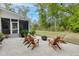 Backyard patio seating area with a fire pit and string lights at 3361 Olivia Marie Ln, Johns Island, SC 29455