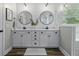 A white bathroom with double vanity and framed mirrors at 3361 Olivia Marie Ln, Johns Island, SC 29455