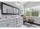 Light and airy bathroom with double vanity, large mirror, and modern finishes at 3361 Olivia Marie Ln, Johns Island, SC 29455