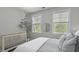 Bright bedroom with a crib next to windows and a well made bed at 3361 Olivia Marie Ln, Johns Island, SC 29455