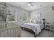 Bright bedroom with a crib and a well made bed next to windows at 3361 Olivia Marie Ln, Johns Island, SC 29455