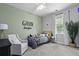 Bright bedroom with a gray accent wall and a well made bed at 3361 Olivia Marie Ln, Johns Island, SC 29455
