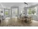 Open-concept dining room with wood floors, modern light fixture, and views to entry and living room at 3361 Olivia Marie Ln, Johns Island, SC 29455
