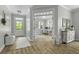 Inviting entryway with hardwood floors and views of the bright, modern home office, featuring a white desk at 3361 Olivia Marie Ln, Johns Island, SC 29455