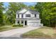 Charming two-story home with a well-manicured lawn and a long driveway surrounded by mature trees at 3361 Olivia Marie Ln, Johns Island, SC 29455