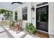Inviting front porch with rocking chairs, plants, and a welcome mat by the door to create a warm, welcoming entrance at 3361 Olivia Marie Ln, Johns Island, SC 29455