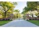 A gated entrance with brick columns provides privacy and security to the property surrounded by trees at 3361 Olivia Marie Ln, Johns Island, SC 29455