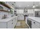 Bright kitchen with quartz countertops, farmhouse sink, wooden floors and stainless steel appliances at 3361 Olivia Marie Ln, Johns Island, SC 29455