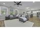 Inviting open-concept living room featuring a large sectional, view of the kitchen, and plenty of light at 3361 Olivia Marie Ln, Johns Island, SC 29455