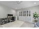 Well lit living room featuring a ceiling fan, shelving and home office at 3361 Olivia Marie Ln, Johns Island, SC 29455