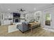 Beautifully decorated living room with fireplace, built-ins, gray sofa, and access to the outdoors at 3361 Olivia Marie Ln, Johns Island, SC 29455