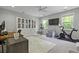 Well lit living room featuring a ceiling fan, tv and workout bike at 3361 Olivia Marie Ln, Johns Island, SC 29455
