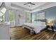 Comfortable main bedroom with hardwood floors, tray ceilings, and lots of natural light at 3361 Olivia Marie Ln, Johns Island, SC 29455