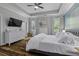 Spacious bedroom featuring tray ceilings, hardwood floors, and bright natural lighting at 3361 Olivia Marie Ln, Johns Island, SC 29455