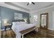 Light-filled main bedroom features hardwood floors and a doorway into the bathroom at 3361 Olivia Marie Ln, Johns Island, SC 29455