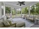 Enjoy the outdoors in this cozy screened porch with stylish furniture and serene backyard views at 3361 Olivia Marie Ln, Johns Island, SC 29455