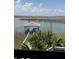 Waterfront view with dock, with seating and cooking space at 3807 Scott Creek Dr, Edisto Island, SC 29438
