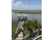 Waterfront view with dock, with seating and cooking space at 3807 Scott Creek Dr, Edisto Island, SC 29438