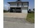 Elevated home with garage parking and a large concrete driveway at 3807 Scott Creek Dr, Edisto Island, SC 29438