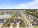 Aerial view of a neighborhood showcasing the lake, well-maintained lawns, and community ambiance at 401 Carrara Dr, Summerville, SC 29486
