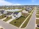 Aerial view of a neighborhood with houses, lawns, a lake and a red car in the driveway at 401 Carrara Dr, Summerville, SC 29486