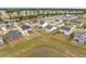 Aerial view of a neighborhood featuring a pond, green lawns, fenced yards and houses at 401 Carrara Dr, Summerville, SC 29486
